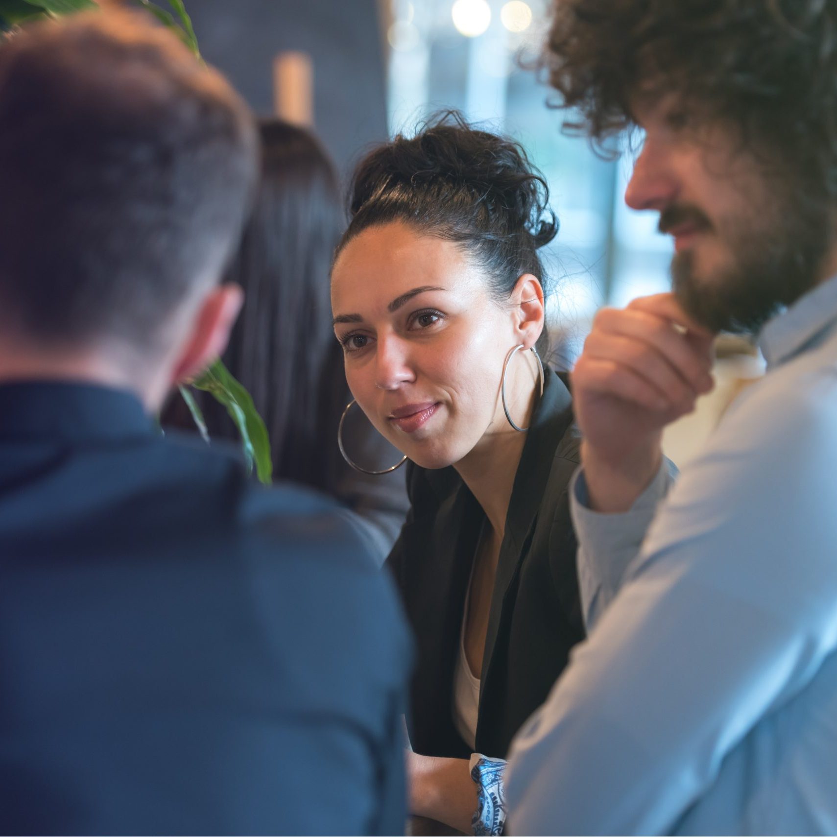 Young business people talking with each other about new projects at a coffee bar